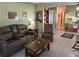 A comfortable living room featuring tiled floor, a leather sofa and a wooden coffee table at 3827 15Th N Ave, St Petersburg, FL 33713