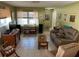 A living room with tile floors, a large window, and comfortable furniture at 3827 15Th N Ave, St Petersburg, FL 33713