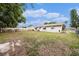 Large backyard showcasing the home's exterior and potential for outdoor activities at 4312 Las Vegas Dr, New Port Richey, FL 34653