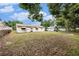 Lush backyard with shade trees, perfect for outdoor relaxation and entertaining at 4312 Las Vegas Dr, New Port Richey, FL 34653
