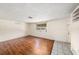Living room with laminate flooring, window with blinds and natural light at 4312 Las Vegas Dr, New Port Richey, FL 34653