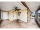 Enclosed patio featuring a ceiling fan, stone accents, and multiple entry doors at 4312 Las Vegas Dr, New Port Richey, FL 34653