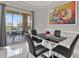 Dining area with tile floor, modern table/chairs, contemporary light fixture, and slider to outside at 4333 Bayside Village Dr # 110, Tampa, FL 33615