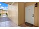Condo entrance showing walkway with decorative tile, white front door, and exterior sconce at 4333 Bayside Village Dr # 110, Tampa, FL 33615