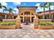 Attractive building exterior with fountain, landscaping and brick paved walkway at 4333 Bayside Village Dr # 110, Tampa, FL 33615