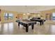 Bright community game room featuring two covered pool tables under pendant lighting, and tile flooring at 4333 Bayside Village Dr # 110, Tampa, FL 33615