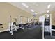 Well-equipped gym offering various exercise machines, weights, and a wall-mounted television for entertainment at 4333 Bayside Village Dr # 110, Tampa, FL 33615