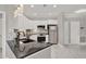 Kitchen featuring white cabinetry, granite counters, tile backsplash, and stainless steel appliances at 4333 Bayside Village Dr # 110, Tampa, FL 33615
