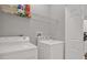 Functional laundry room with side-by-side washer and dryer and storage shelves for convenience at 4333 Bayside Village Dr # 110, Tampa, FL 33615
