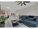 Living room featuring a gray sectional sofa, tile flooring, contemporary decor, and open to the dining and kitchen at 4333 Bayside Village Dr # 110, Tampa, FL 33615