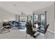 Open concept living room and dining room with tile floors, fan, modern furniture, and large windows at 4333 Bayside Village Dr # 110, Tampa, FL 33615