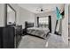 Main bedroom featuring a dark bedroom set, TV, modern decor, window, and tile floors at 4333 Bayside Village Dr # 110, Tampa, FL 33615