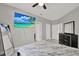 Main bedroom featuring a dark bedroom set, TV, modern decor, and tile floors at 4333 Bayside Village Dr # 110, Tampa, FL 33615