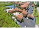 Aerial view of the community pool, lake, and parking, featuring lush landscaping and inviting amenities at 4333 Bayside Village Dr # 110, Tampa, FL 33615