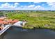 An aerial view of the community pool and boardwalk, with lush greenery and lake views at 4333 Bayside Village Dr # 110, Tampa, FL 33615