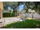 Backyard showing paved area and surrounding grass and privacy fence at 4518 W Woodmere Rd, Tampa, FL 33609