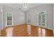 Bright bedroom with wood floors and three windows at 4518 W Woodmere Rd, Tampa, FL 33609