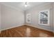 Bright bedroom with wood floors, ceiling fan and two windows at 4518 W Woodmere Rd, Tampa, FL 33609