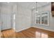 Bright dining area features hardwood flooring, a modern light fixture, and a large window at 4518 W Woodmere Rd, Tampa, FL 33609