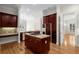 Spacious kitchen with modern appliances, granite counters and an island with a cooktop at 4518 W Woodmere Rd, Tampa, FL 33609