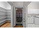 Convenient laundry room with shelving, washer, dryer, sink, and easy access to the garage at 4518 W Woodmere Rd, Tampa, FL 33609