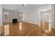 Spacious living room featuring hardwood floors, a fireplace, and an arched doorway leading to the front entrance at 4518 W Woodmere Rd, Tampa, FL 33609