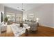 Comfortable living room featuring hardwood floors, a ceiling fan, and sliding glass doors to the outdoor spaces at 4518 W Woodmere Rd, Tampa, FL 33609