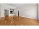 Expansive living room with hardwood floors and lots of space, leading to the kitchen and other areas of the house at 4518 W Woodmere Rd, Tampa, FL 33609