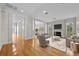 Bright living room with fireplace, hardwood floors, columns, and lots of natural light from the many windows at 4518 W Woodmere Rd, Tampa, FL 33609