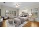 Serene main bedroom featuring hardwood floors, plantation shutters, soft neutral tones, and elegant decor at 4518 W Woodmere Rd, Tampa, FL 33609