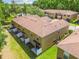 Aerial view of multiple townhomes showing the roofs and back patios at 4528 Winding River Way, Land O Lakes, FL 34639
