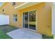 A sliding glass door opens to a back patio and view to the lawn at 4528 Winding River Way, Land O Lakes, FL 34639