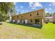 This home includes a spacious backyard with green grass and a privacy fence at 4528 Winding River Way, Land O Lakes, FL 34639