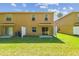 The spacious backyard features green grass and a privacy fence at 4528 Winding River Way, Land O Lakes, FL 34639
