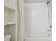 Bathroom featuring a white shower/tub combo, white tiled walls and white vanity at 4528 Winding River Way, Land O Lakes, FL 34639