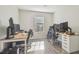 Bright bedroom features two work stations, wood floors, and natural light at 4528 Winding River Way, Land O Lakes, FL 34639