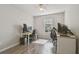 Bedroom with wood flooring features two work stations, natural light, and a ceiling fan at 4528 Winding River Way, Land O Lakes, FL 34639