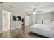 The bedroom boasts wood floors, a ceiling fan, and easy access to the ensuite bathroom at 4528 Winding River Way, Land O Lakes, FL 34639
