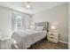 Bedroom featuring dark wood floors, neutral walls, ceiling fan and natural light at 4528 Winding River Way, Land O Lakes, FL 34639