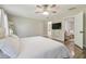 This spacious bedroom features a ceiling fan and includes a view of the ensuite bathroom at 4528 Winding River Way, Land O Lakes, FL 34639