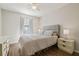 Bedroom features wood floors, a ceiling fan, and natural light from a window at 4528 Winding River Way, Land O Lakes, FL 34639