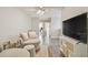 Bonus room with television and view into bedroom at 4528 Winding River Way, Land O Lakes, FL 34639