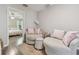 Bonus room has cozy seating area and view into bedroom at 4528 Winding River Way, Land O Lakes, FL 34639