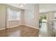 Bright dining room features wood flooring, large window with decorative curtains at 4528 Winding River Way, Land O Lakes, FL 34639
