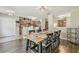 Open-concept dining room showcases a wood table and leads into the kitchen at 4528 Winding River Way, Land O Lakes, FL 34639