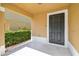 Covered entryway with neutral paint and adjacent landscaping at 4528 Winding River Way, Land O Lakes, FL 34639
