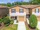 Well maintained townhome with brown shutters, and front lawn at 4528 Winding River Way, Land O Lakes, FL 34639