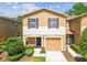 Well maintained townhome with brown shutters, attached garage and front lawn at 4528 Winding River Way, Land O Lakes, FL 34639