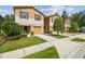 Charming townhome row with a one car garage, manicured landscaping, and neutral color palette at 4528 Winding River Way, Land O Lakes, FL 34639