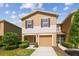 Charming townhome with a one car garage, manicured landscaping, and neutral color palette at 4528 Winding River Way, Land O Lakes, FL 34639